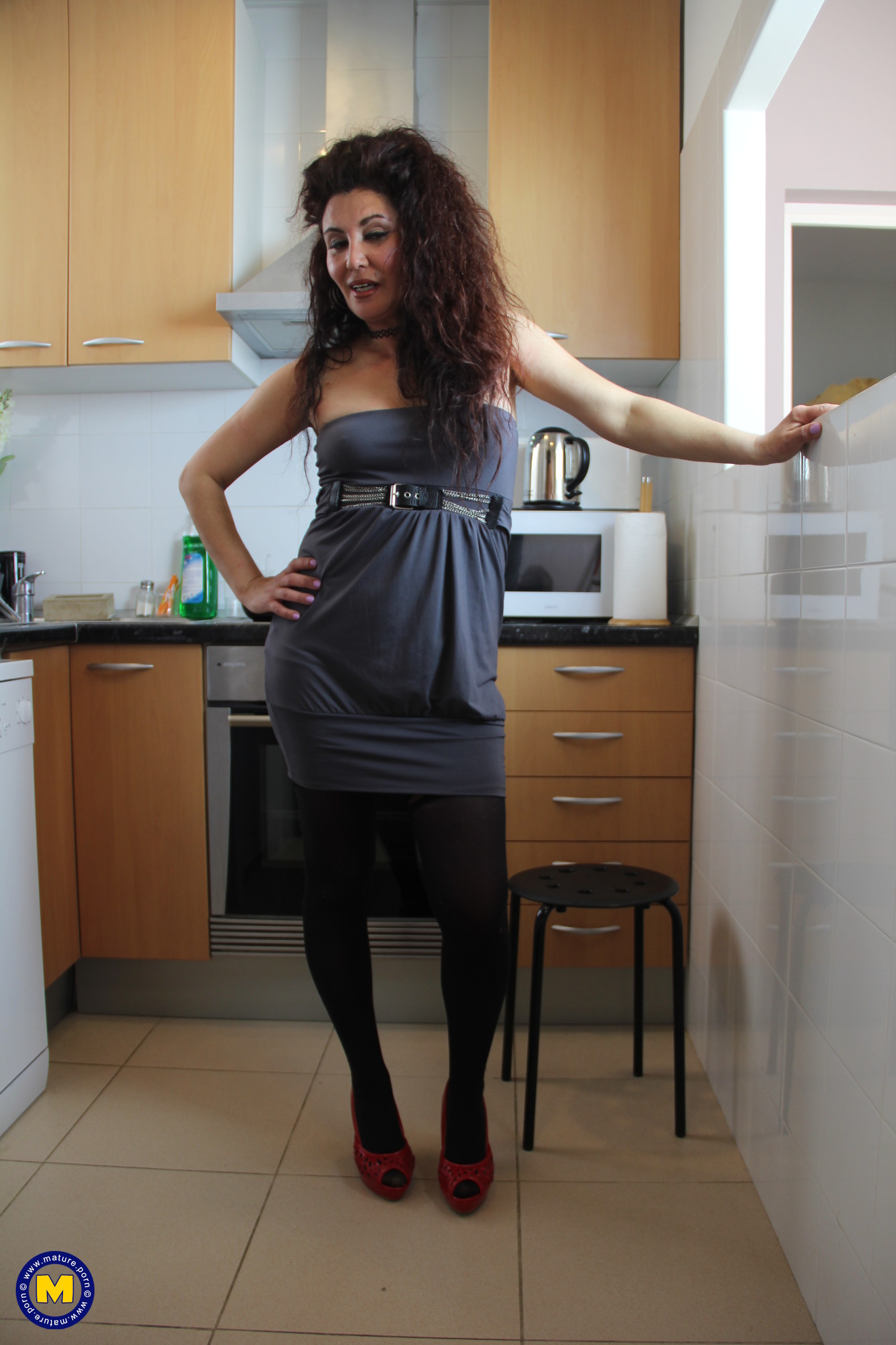 Naughty Spanish housewife playing in her kitchen